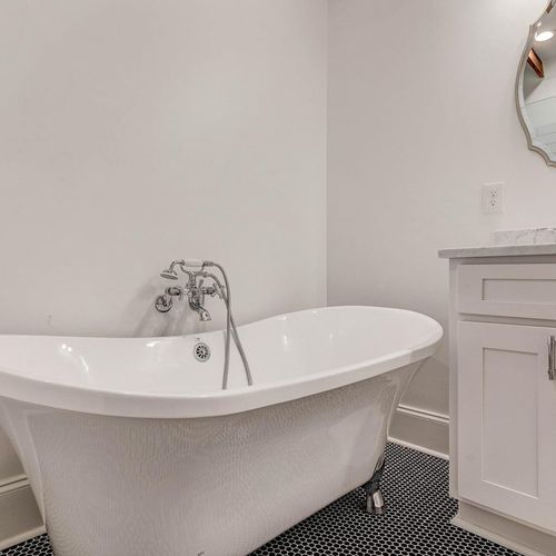 Elegant freestanding soaking tub — the kind of bath you actually look forward to.