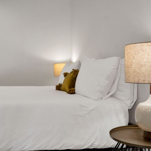 This cozy nook features soft lighting, fresh linens, and a calm vibe—great for catching up on rest after a day in the city.