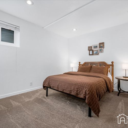 Relax and rejuvenate in the bright and airy downstairs bedroom, featuring a queen size bed.