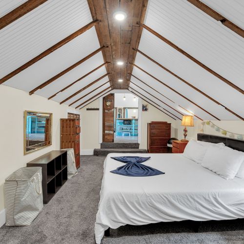 Bright loft bedroom w/ vaulted ceilings & a relaxed, airy feel.