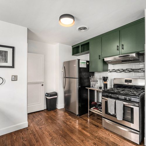 Stainless steel appliances in the open kitchen.