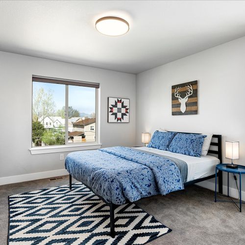 - bright and youthful bedroom with fun wall art, bold patterns, and a comfy double bed