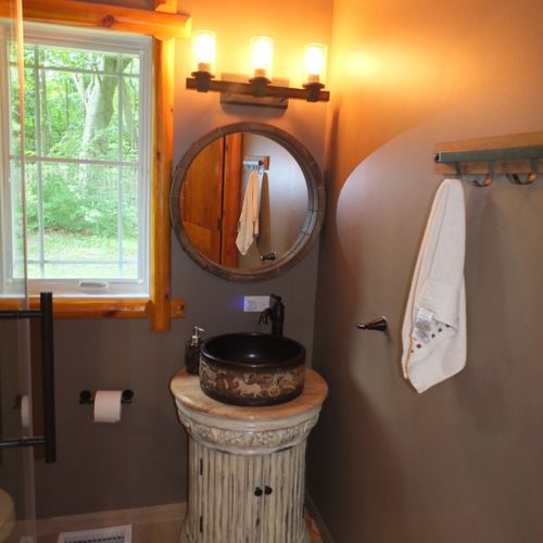 Bedroom #3:  this is the beautiful private en suite bathroom for bedroom #3. It includes a shower, toilet, sink, mirror, and vanity.