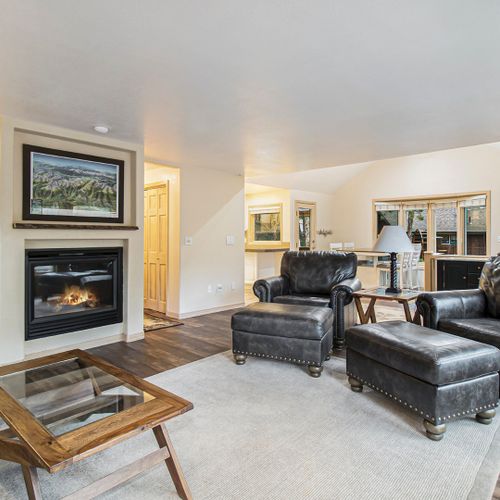 Snuggle up in this living room with a firepit and comfy seating.