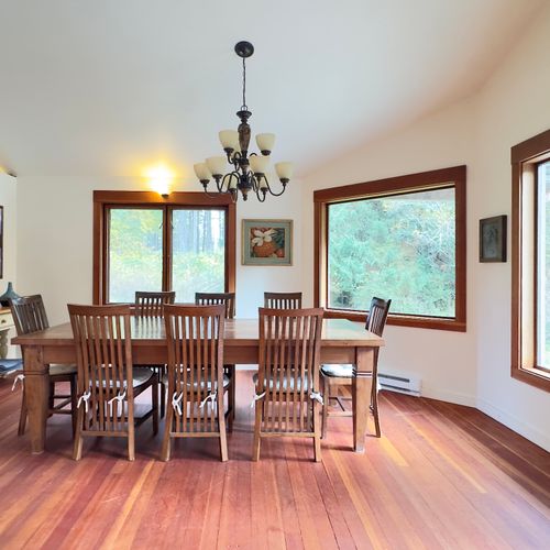 Large, country farm table open to the pond and woods