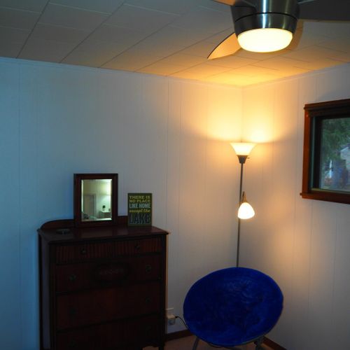Bedroom #1:  features a queen-size bed, nightstands with lamps, ceiling fan, chair, dresser, closet, and full-length mirror.