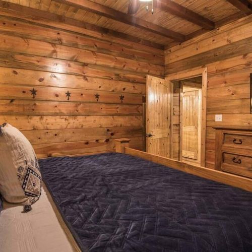 The third bedroom, featuring a king sized bed and smart tv.