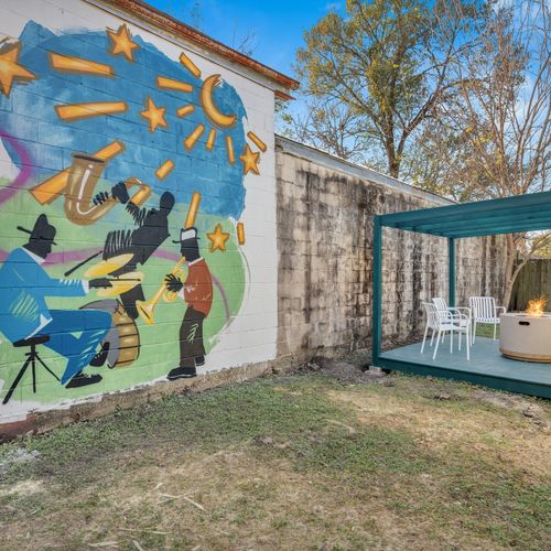 Lively courtyard mural bursting w/ color & true NOLA spirit — an outdoor space with character.