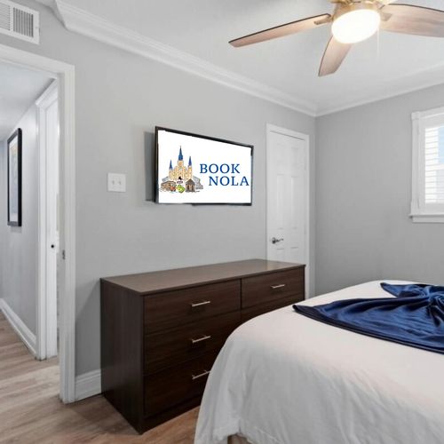 Sleep in style in this sleek bedroom w/ dark wood furniture & clean lines.