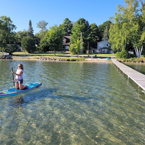 Overview:  the huge dock and gorgeous lakefront right in front of the house. Note that the water is very clear, sandy, and shallow, which makes it great for all kinds of family fun!