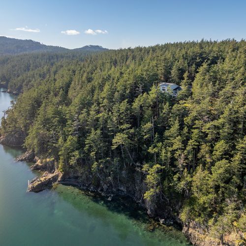 Waterfront adventures.  Follow our winding trail down through five private acres to a private sandy beach and rock outcrop.