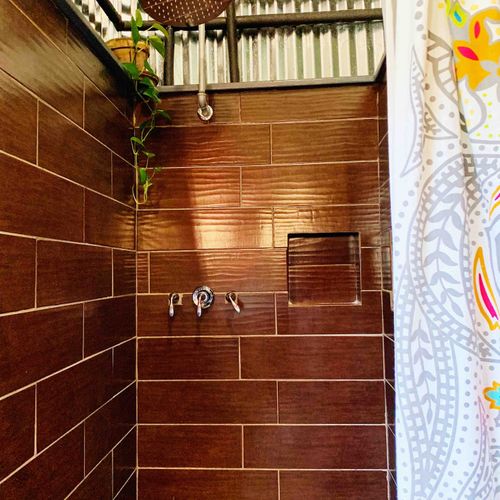 Warm-toned tiled shower — the perfect place to wash off the day.