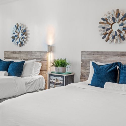 Your dream vacation starts here! This inviting bedroom features two comfortable beds and a direct connection to the beauty of the ocean, just steps from your private balcony.