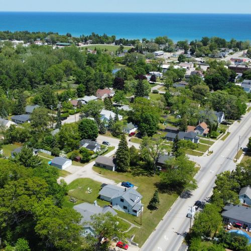 Exterior:  looking northeast with the house in the foreground and downtown oscoda and lake huron in the background.