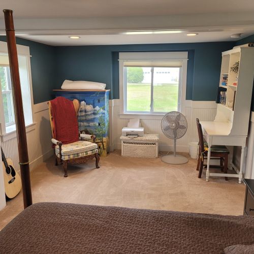Bedroom #1 (larger house, main floor):  features a king-size bed, desk and chair, reading chair, and a huge en suite private full bathroom!