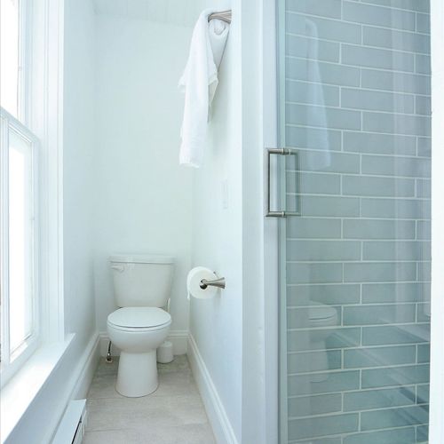 - clean and minimal bathroom with modern glass door shower and stylish tilework
- large window brings in abundant natural light, creating a bright and airy feel
- compact layout with sleek fixtures perfect for a refreshing start to the day