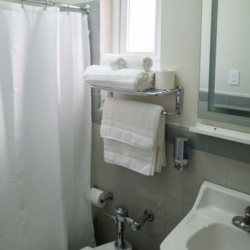 Our immaculate bathroom is always stocked with fresh, fluffy towels and essential amenities, ensuring a clean and comfortable experience for all our guests.