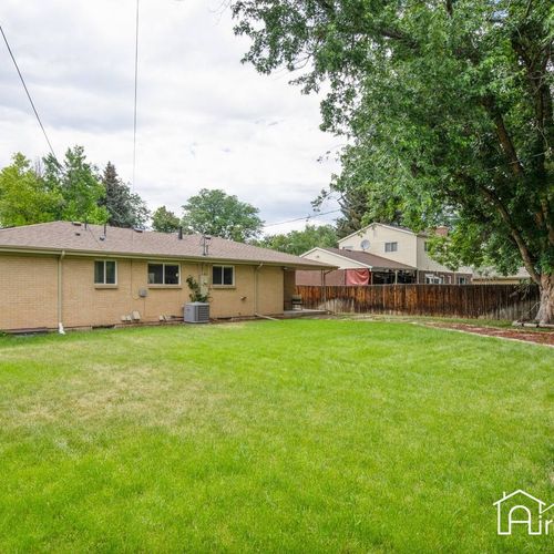 Relax and enjoy the great outdoors in our spacious fenced-in backyard, complete with patio furniture and string lights.