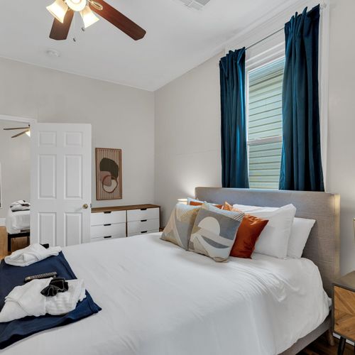 Serene, light-filled bedroom w/ a clean, minimal feel made for deep rest.