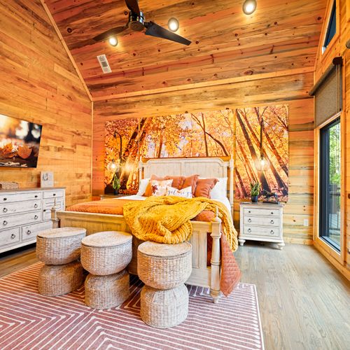 Warm hues, leafy art, and cozy textures make this room feel like a luxury cabin in peak fall.