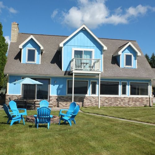 Overall:  a good overview of the back of the house, which faces lake huron. As shown, there is a nice fire ring and also outdoor dining furniture in the backyard.