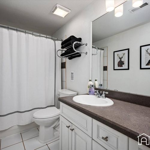 - clean and spacious bathroom with full vanity, plenty of counter space, and towel storage above
- decorative touches like framed art and sleek fixtures add a cozy charm
- ideal for guests or groups needing extra convenience and privacy