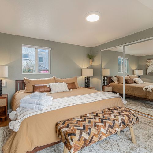 - sink into a king bed with cozy earth tone linens, leather accents, and soft lighting
- wall to wall mirrored closets create a sense of spaciousness and reflect natural light
- warm textures and wood elements offer a peaceful, grounded retreat