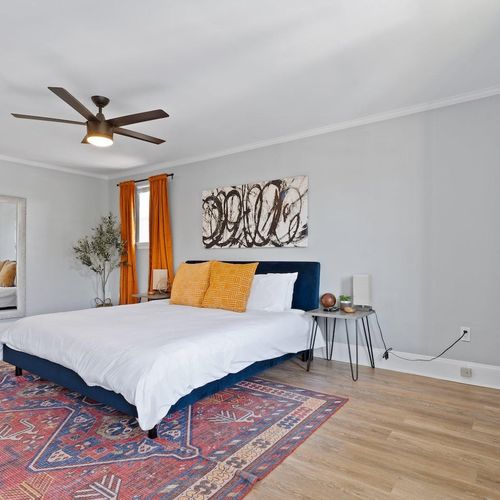 Comfortable bed bathed in warm light — your restful retreat awaits.
