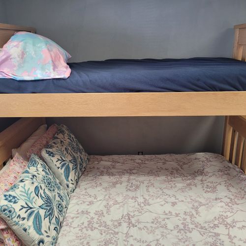 Bedroom:  cute bedroom with a twin-on-full bunk bed, electric heater, fan, 2 dressers, closet, lamp, and a television.