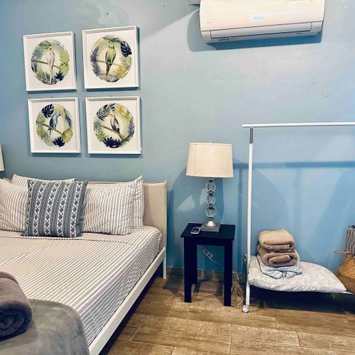 Comfort meets convenience: This image highlights the serene ambiance of our principal bedroom, featuring a generous queen bed and the added comfort of air conditioning.