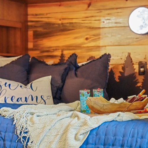 Immerse yourself in this dreamy bunk retreat where every bed feels like its own little cabin in the trees.
