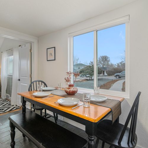 - enjoy breakfast or dinner at this timeless wood dining table that seats four
- bask in the natural light and enjoy calming views of the quiet neighborhood
- ideally positioned with simple access to the kitchen, hallway, and nearby bath