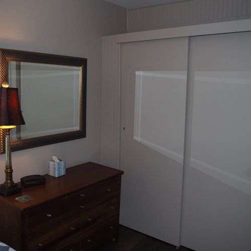Bedroom #1:  features a queen-size bed, nightstand, lamp, dresser, mirror, closet, and television.