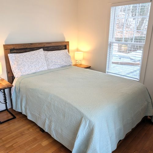 BEDROOM #2 (MAIN FLOOR):  This is a second main floor bedroom that also has a queen-size bed, nightstands, lamps, dresser, mirror, and a closet.