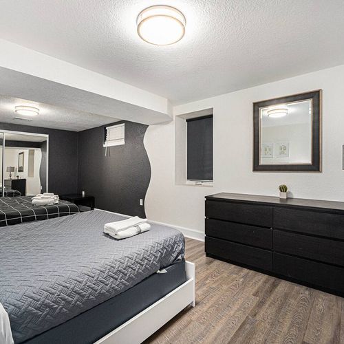 - enjoy extra space and flexibility in this dual bed room with a chic monochrome palette
- modern furnishings, mirrored closet doors, and soft lighting complete the cozy vibe
- ideal for group travelers who want comfort and a touch of design flair