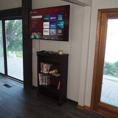 Living room:  the cottage has a cozy living room with a great view of bass lake. Includes live-streaming television with hulu, hbo max, pureflix, netflix, and disney+. (guests are not permitted to use the wood fireplace. )