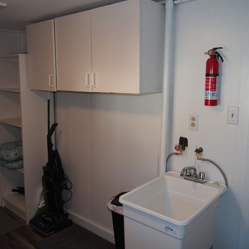 Laundry room:  main floor laundry room with washer, dryer, and sink.