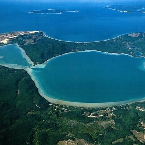 Overall:  a great aerial photo of big glen lake and little glen lake (on which the cabins are located) with sleeping bear dunes, glen arbor, lake michigan, and north and south manitou islands in the background.