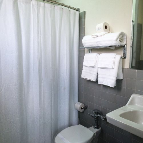 Our spotless bathroom is fully equipped with fresh, fluffy towels and all the essentials, ensuring a clean and comfortable experience for every guest.