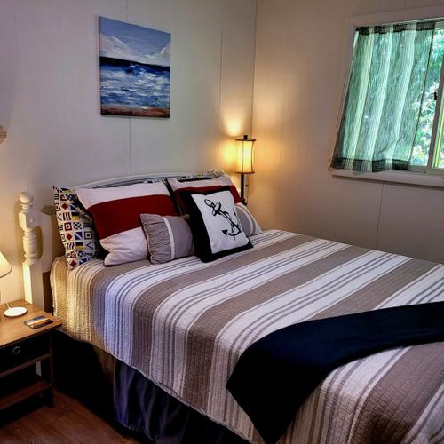 Bedroom #2:  bedroom #2 features a full-size bed, closet, dresser, and nightstands with lamps.