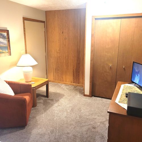 BEDROOM #1 (MAIN FLOOR):  Huge primary bedroom on the main floor with private ensuite bathroom and its own television, kitchenette, and dining table!