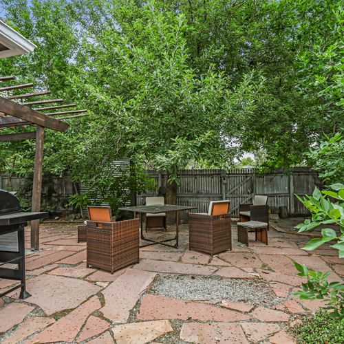 The backyard hideaway is perfectly complemented by comfy outdoor furniture and an inviting firepit. Please note the pergola has been removed and patio furniture may be put into storage during the winter months.