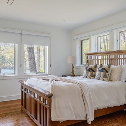 Two levels down, you'll find the next wing of bedrooms, with this queen room featuring additional lake views.