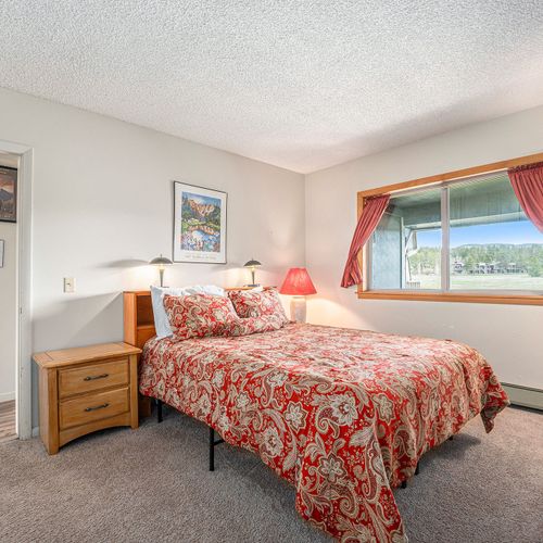Wake up to serene forest views from the master bedroom window.
