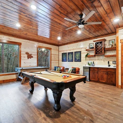 A pool table, air hockey and wet bar are a few of the amenities found downstairs