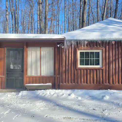 Exterior:  the side entrance to the cabin (which is the main entrance in the winter)