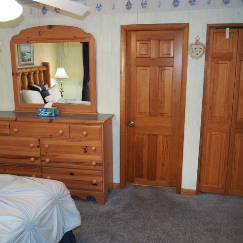 Bedroom #1 (main floor):  features a queen-size bed, private television, dresser, ceiling fan, closet, and en suite private bathroom.