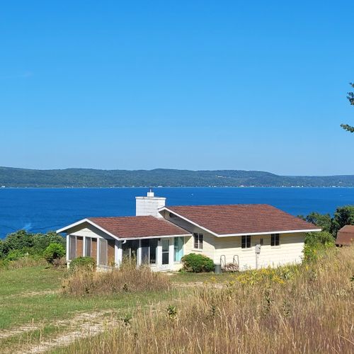 Exterior:  another view of the cottage with crystal lake in the background.