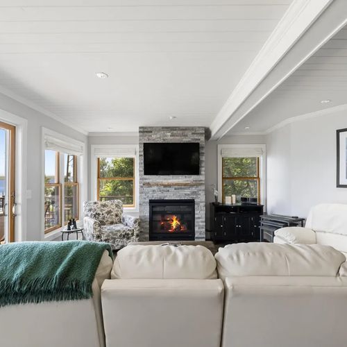 LIVING ROOM (MAIN FLOOR):  The home has a stunning living room with a spectacular view of Crystal Lake and a natural gas fireplace