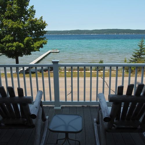 Exterior:  the relaxing adirondack chairs on the deck with the private dock and the lake in the background.